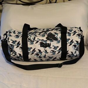 Patterned White Duffel Bag with Blue & Black Accents